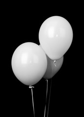 Three white balloons isolated on black