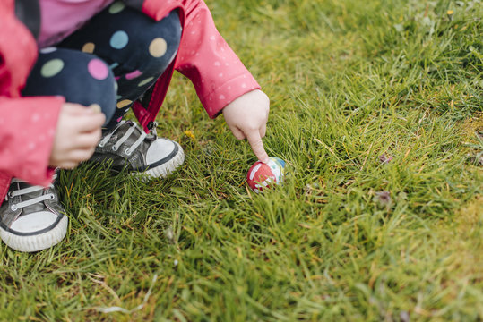 Child on the grass with Easter egg