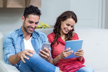 Smiling couple using technology 