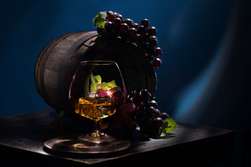 Obraz na płótnie Canvas Grape brandy and ice near the old oak barrels