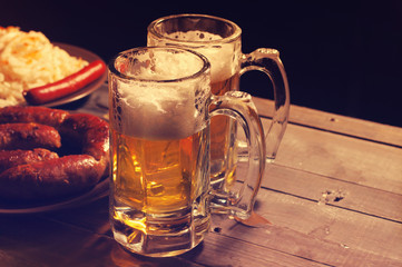 Beer in a glass on wooden background. Beer and beer snack.