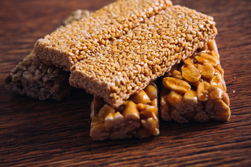 Kozinaki of sesame and peanut on a wooden background