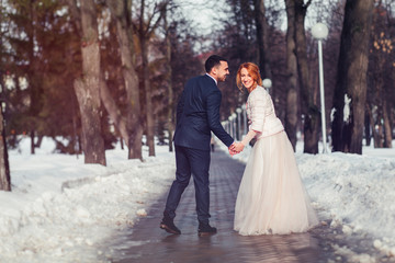 gorgeous elegant luxury bride and stylish groom hugging and walk