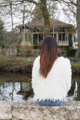 woman resting on a park bench looking at the distance deep in thought