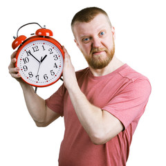 Resents bearded man with an alarm clock