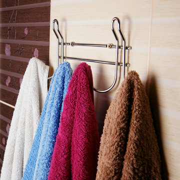 colored towels hanging on the rack in the bathroom.