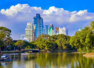 Fototapeta na wymiar Lumpini Park , lake , modern apartments in downtown Bangkok, Thailand