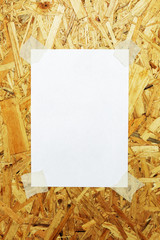White sheet of paper glued to plywood