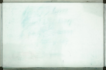 Old whiteboard for office with traces of stains and spots