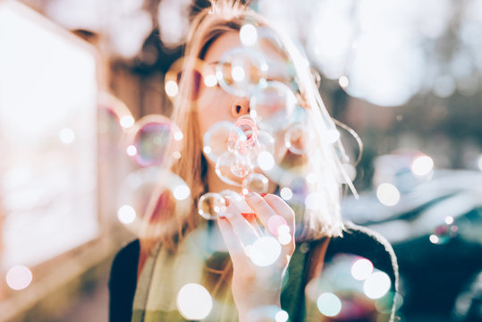 Close Up On The Hand Of Young Beautiful Woman Blowing Bubble Soa