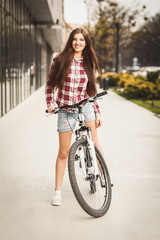 Young beautiful woman on a bicycle