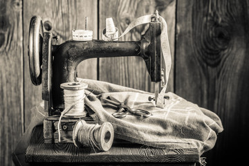 Vintage sewing machine with needle, threads and tailor tape