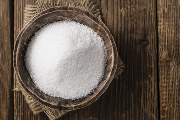 White Sugar (selective focus) on wooden background