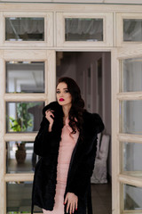 Beautiful girl model in a black coat