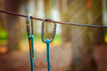 Climbing Sports Image Of A Carabiner On A Metal Rope In A Forest