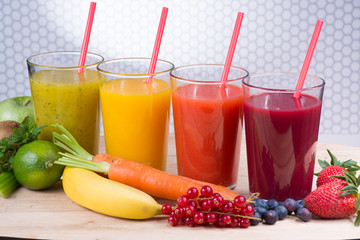 Colofrul fresh pressed fruit juices in tall glasses with fruits