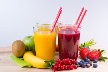 Colofrul fresh pressed fruit juices in tall glasses with fruits