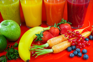 Colofrul fresh pressed fruit juices in tall glasses with fruits