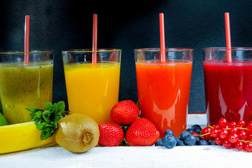 Colofrul fresh pressed fruit juices in tall glasses with fruits