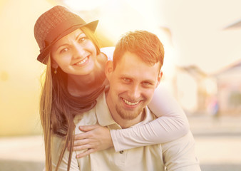 Smiling happiness couple funing on the street.