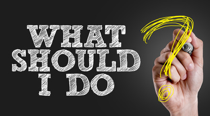 Hand writing the text: What Should I Do?