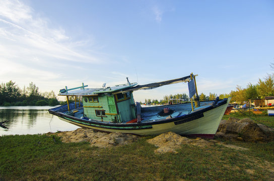 Old abandoned fisherman boat on the riverside