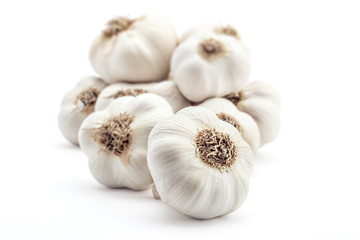 Pile of fresh organic garlic isolated on white background