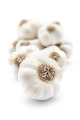 Pile of fresh organic garlic isolated on white background