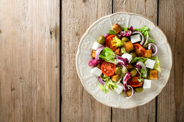 Fresh salad with feta cheese, olives and tomatoes