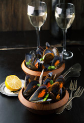 Mussels in wooden bowls and white wine