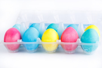 Colorful easter eggs in package isolated.