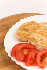 Chicken white meat served with tomato salad