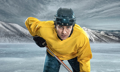 Ice hockey player on the ice in mountains