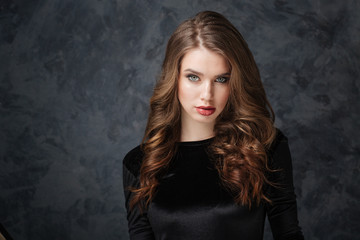 Fototapeta premium Gorgeous young woman with long curly hair