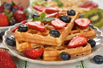 Waffles with berries and caramel sauce