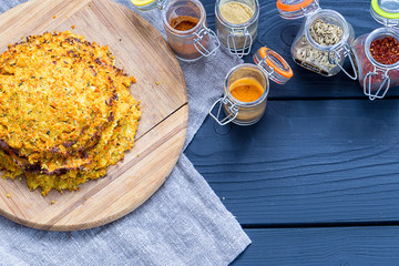 Indian Pancakes with Bottles of Spices on Dark Wooden Background, Top View