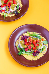 Chicken and Salad Tortilla with Avocado on Orange Background, Top View, Vertical View