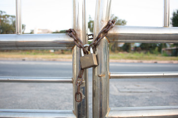 Gold Padlock with chain used on a chainlink fence. Selective foc
