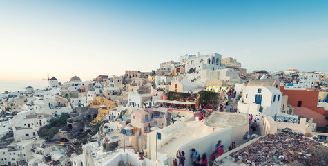 Naklejka premium OIA, GREECE - MAY 12, 2014: Tourists await the famous sunset in