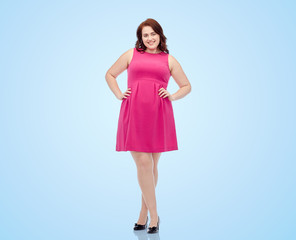 happy young plus size woman posing in pink dress