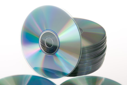 Stack of CDs and DVDs on a white background