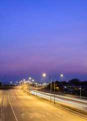 Fototapeta na wymiar Car light trails on motorway with beautiful skyscape at twilight