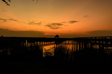 Fototapeta na wymiar Silhouette scene of Wooden bridge at Sam Roi Yod National Park,prachuap khiri khan,Thailand