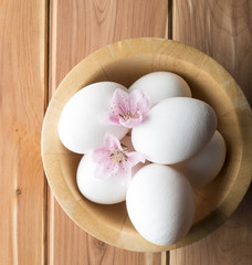 eggs with flower of peach on the wooden table