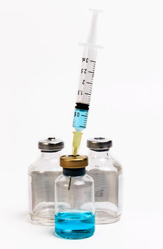 Vaccine in vial with syringe on a white background. Close up.