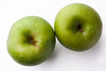 Two green fresh ripe apples on white background directly from above