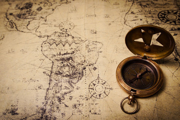 old brass compass on wood table top view