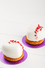 White heart shaped mousse cakes in glaze