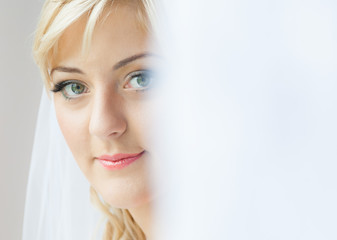 Portrait of a charming bride with beautiful smile and red lipstick