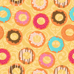 Seamless vector yellow background with different donuts